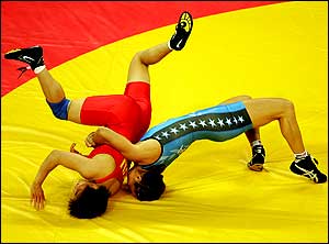 Sara McMann of the USA flips Lili Meng of China