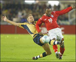 Sweden's Olof Mellberg fouls England's Darius Vassell