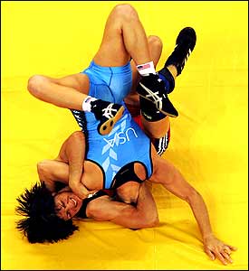 Greece's Stavroula Zygouri lifts Sara McMann of the USA during the women's freestyle wrestling 63 kg qualification encounter