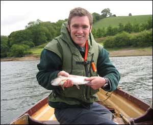 Dean Cook catching his first ever fish, a rainbow trout in Llys y fran reservoir, Pembrokeshire