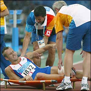 Chris Rawlinson sustains an injury after clattering into the first hurdle and is stretchered off after struggling over the finish line