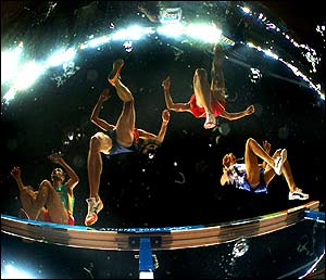 Athletes compete in the men's 3000m steeple chase