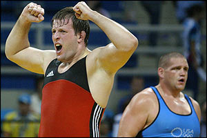 Georgiy Tsurtsumia celebrates while defending champion Rulon Gardner stands dejected