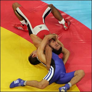 Seref Eroglu of Turkey (blue) grapples with Azerbaijan's Farid Mansurov