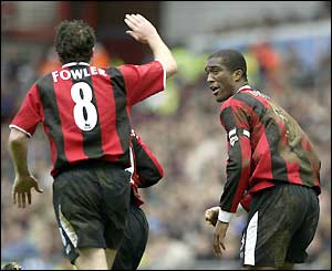 Robbie Fowler celebrates City's equaliser with Sylvain Distin