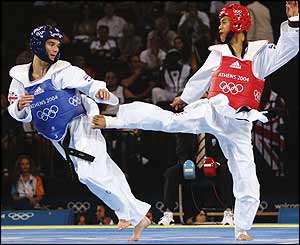 Paul Green (blue) moves away from the kick of Vietnam's Quoc Huan Nguyen