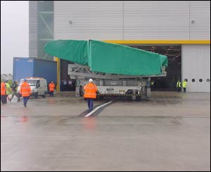 The wing is moved out of the factory