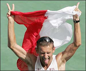 Poland's Robert Korzeniowski celebrates after winning the men's 50km walk