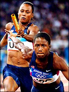 USA's Marion Jones passes the baton to Lauryn Williams as they compete in round one of the women's 4 x 100m relay 