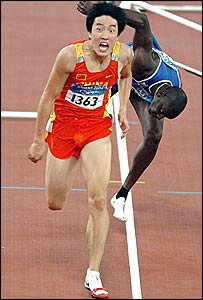 France's pre-race favourite Ladji Doucoure stumbles in last behind winner Xiang Liu (red)