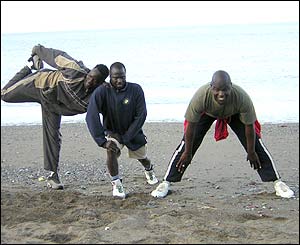 Migrants exercising on the beach in Ceuta