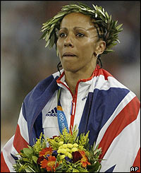 Kelly Holmes stands on the podium as double Olympic champion