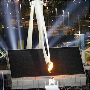 The Olympic flame is lowered 