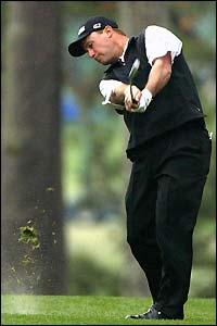 Chris DiMarco plays his second shot at the first hole