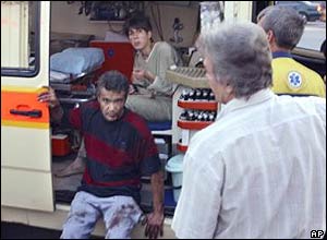 Two injured people are treated in an ambulance at the scene