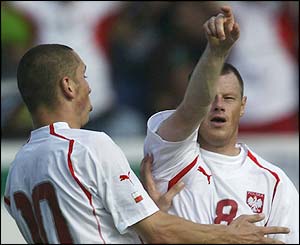 Jacek Krzynowek celebrates scoring Poland's third