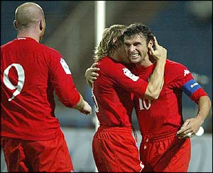 John Hartson and Craig Bellamy congratulate Gary Speed after he opens the scoring for Wales