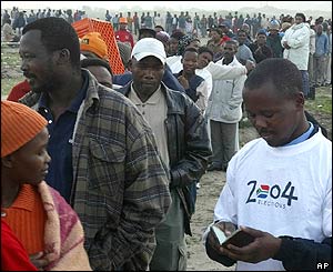 An official checks papers at a voting station in Khayelitsha, Cape Town