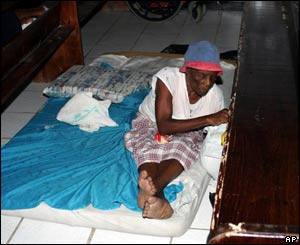 Her home damaged, a woman takes shelter from the fierce winds in a church in Castries, St Lucia