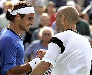 Roger Federer of Switzerland hits a backhand to Andre Agassi during their match at the Arthur Ashe Stadium