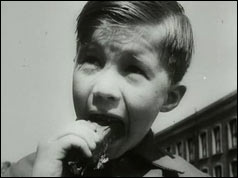 Boy eats chocolate bar 