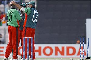 Kenya's Martin Suji, left, receives a pat on the head from teammate Ravindu Shah as he celebrates taking the wicket of India's captain Sourav Ganguly 