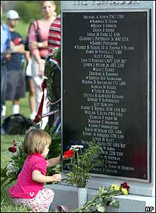 Girl lays a flower at a memorial for the victims of the 9/11 attack in Washington