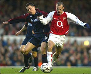 Middlesbrough's Stewart Downing challenges Freddie Ljungberg, who scores Arsenal's fourth goal