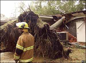 A fire-fighter in Alabama examines the damage to a house in Dothan