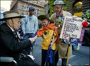 Daniel Roberts, in yellow, shakes the hand of Marcel Caux, left, as Pat Lee, right, looks on prior to the start of the parade in Sydney on Sunday