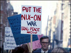 Demonstrator holds placard that reads: 