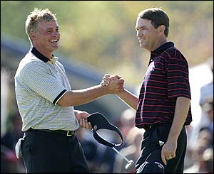 Clarke and Love shake hands after halving their match