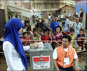 Woman votes at a polling station in Jakarta, Indonesia, Monday 20 September