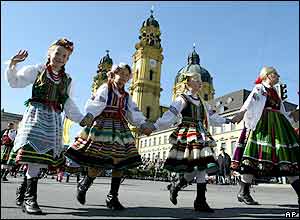 A group from Poland wears traditional clothes in front of the Theatiner church