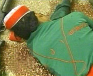 Dead militant with a T-shirt emblazoned with the words JI