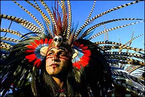 Jorge Medina of San Jose, California, wearing a headdress of pheasant and macaw feathers