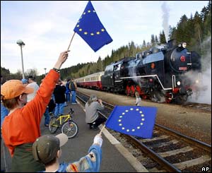 Two Bavarian boys wave EU flags as a special train steams into the railway station across the Czech-German border 