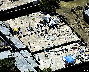 Gonaives residents on the roofs of their submerged homes.