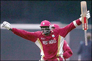 Courtney Browne holds his arms aloft