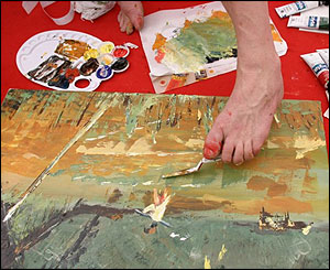 Artist using their foot to paint.