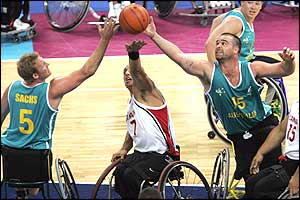 Canada's Richard Peter (centre) fights for the ball with Australia's Troy Sachs (left) and Brad Ness