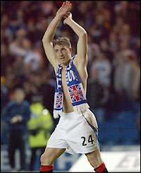 Gregory Vignal salutes the Rangers fans after scoring the winning penalty