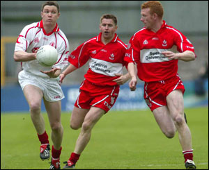 Enda McGinley is chased by Conleth Gilligan and Fergal Doherty