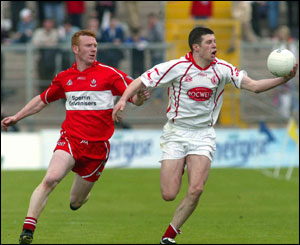 Sean Cavanagh beats Fergal Doherty to possession