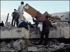 Rescuers shifting rubble 