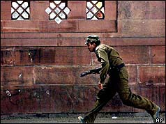 Police commando runs for cover