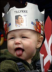 Ten-month-old Sofus enjoys himself outside Amalienborg castle wearing a crown wishing the royal couple good luck in Copenhagen, 14 May 2004, 