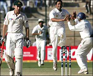 Katich looks dejected while Kumble celebrates his wicket