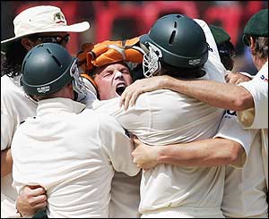 Shane Warne is mobbed by his team-mates after removing Venkatsai Laxman