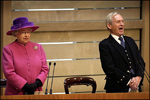 Presiding Officer George Reid gives a hearty rendition of Auld Lang Syne while the Queen looks a little less sure 